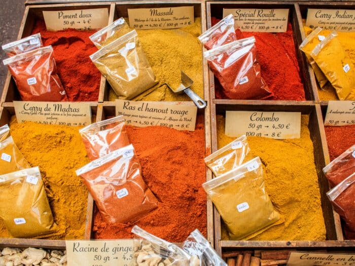 Vibrant spices displayed at a local market in Nice, France, showcasing diverse colors and flavors.